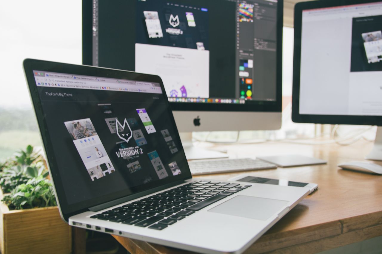 Why Business Intelligence Is Imperative for Sound Decision-Making A stylish workspace featuring a laptop and monitors displaying design software.